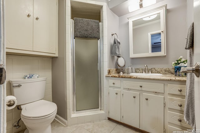 8058 Broadway Unit 147U, San Antonio, TX 78209 - bathroom featuring toilet, vanity, a shower stall, tile patterned floors, and tile walls