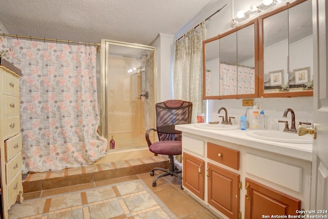 bathroom featuring a shower, vanity, a textured ceiling, and tile patterned floors