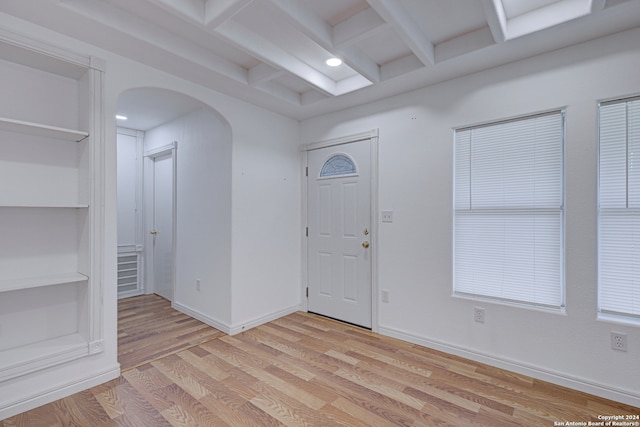 entrance foyer with beamed ceiling and light wood-type flooring