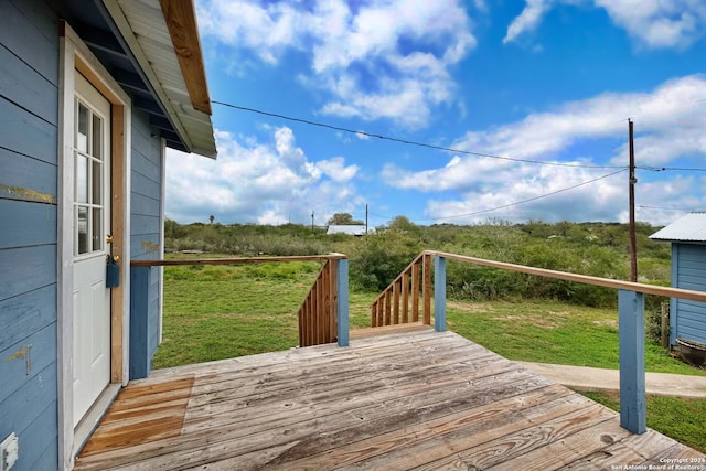 wooden terrace with a lawn