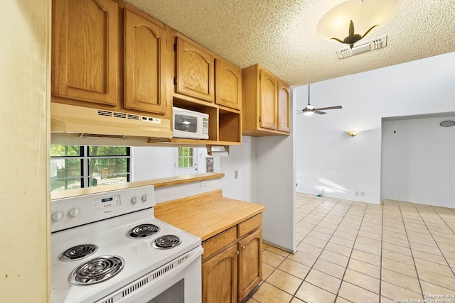 kitchen featuring ceiling fan, light tile patterned flooring, white appliances, and a textured ceiling