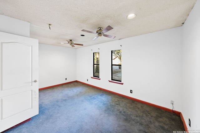 carpeted spare room with a textured ceiling and ceiling fan