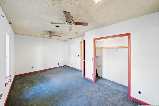 unfurnished bedroom featuring ceiling fan, dark carpet, a textured ceiling, and a closet