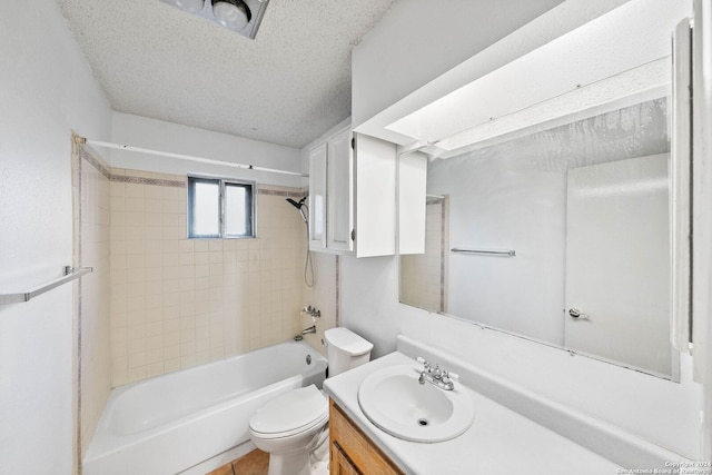 full bathroom with vanity, a textured ceiling, tiled shower / bath combo, tile patterned flooring, and toilet