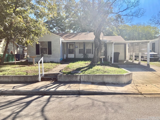 ranch-style home featuring a carport, a front yard, and a garage