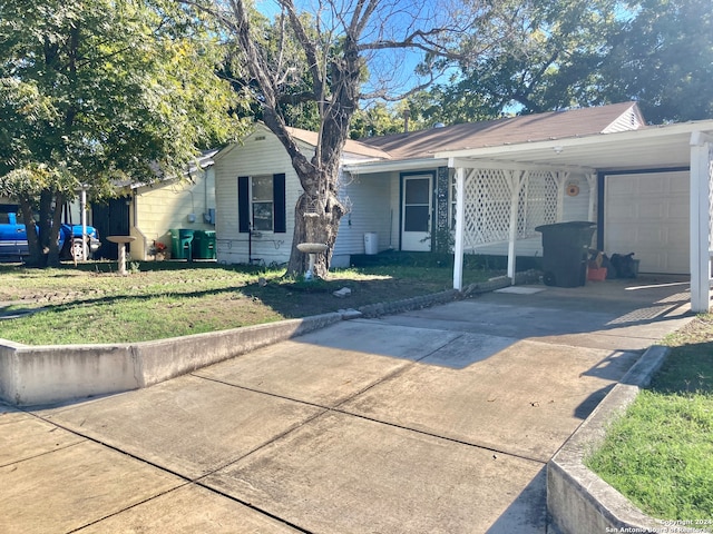 ranch-style home with a front yard, a garage, and a carport