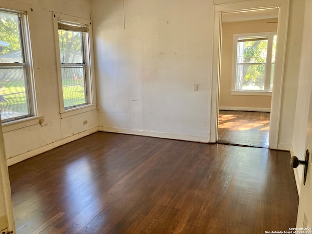 unfurnished room featuring dark hardwood / wood-style floors