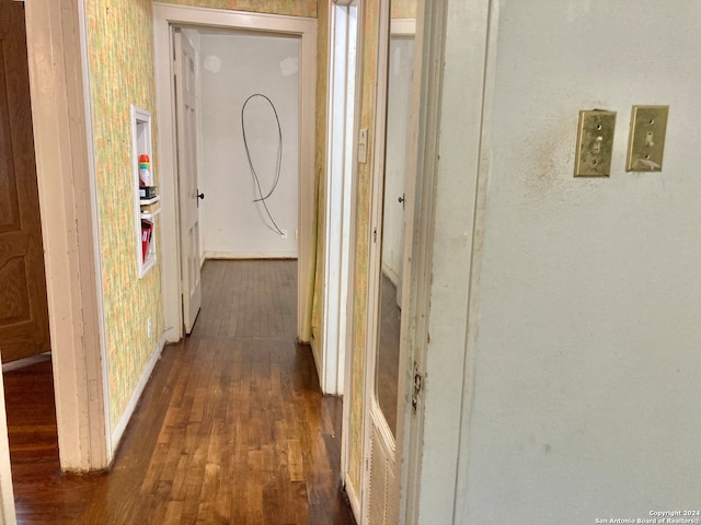 hallway with dark hardwood / wood-style floors