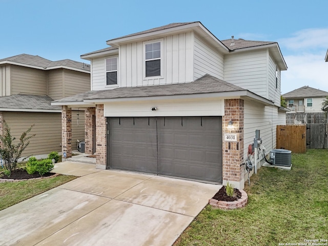 view of front facade featuring central AC unit, a garage, and a front lawn