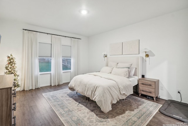 bedroom with dark hardwood / wood-style floors