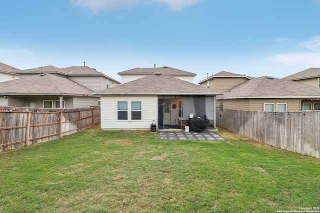 rear view of house with a yard