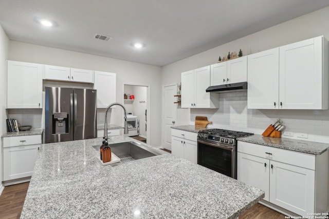 kitchen featuring appliances with stainless steel finishes, sink, a center island with sink, white cabinets, and dark hardwood / wood-style floors