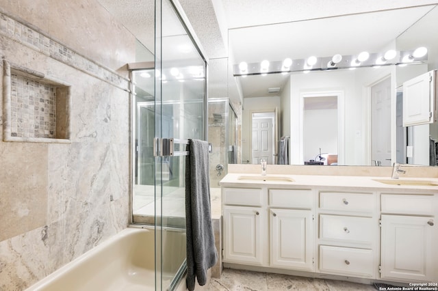 bathroom with shower / bath combination with glass door and vanity