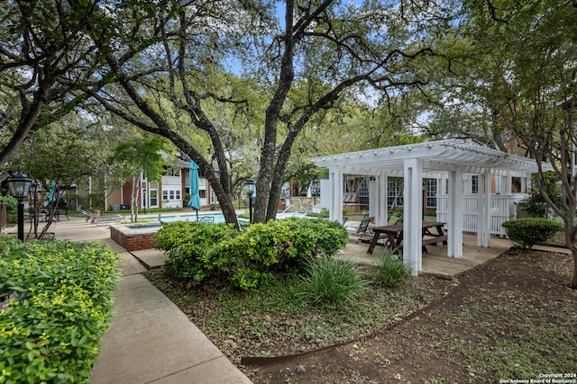 view of community featuring a pool and a pergola