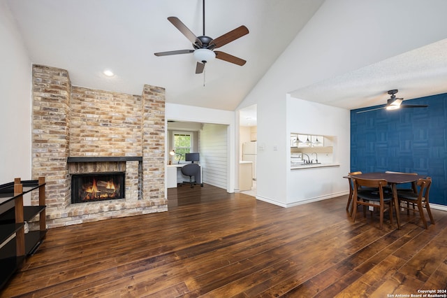 living room featuring ceiling fan, dark hardwood / wood-style flooring, and a fireplace