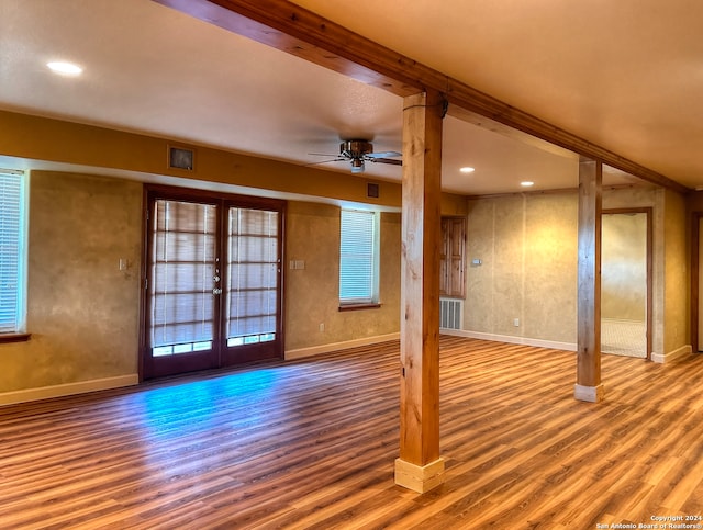 unfurnished living room with hardwood / wood-style floors, french doors, ceiling fan, and a healthy amount of sunlight