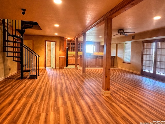 interior space featuring ceiling fan, hardwood / wood-style floors, and a textured ceiling