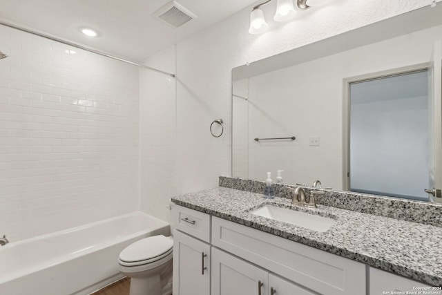 full bathroom featuring vanity, toilet, and tiled shower / bath