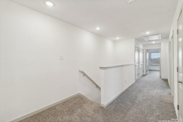 hallway with light colored carpet