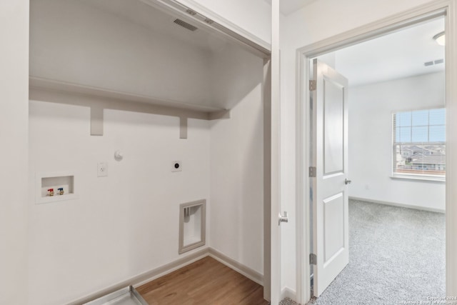 laundry area featuring washer hookup, electric dryer hookup, gas dryer hookup, and light carpet