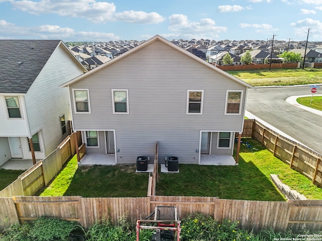 back of property featuring a yard, a patio, and central AC