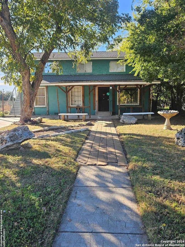 view of front of property with a porch and a front yard