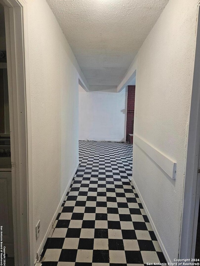 hallway with a textured ceiling