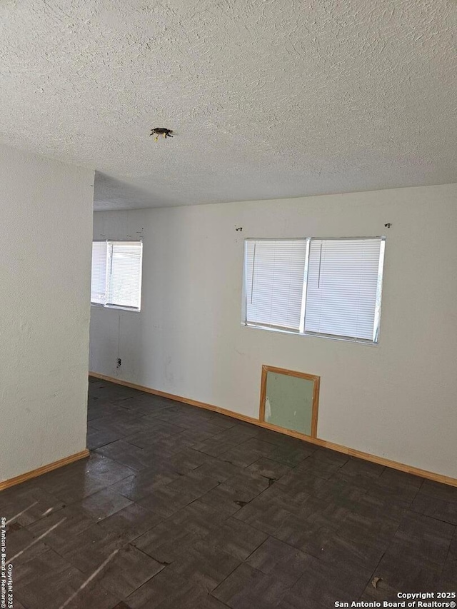 spare room with a textured ceiling