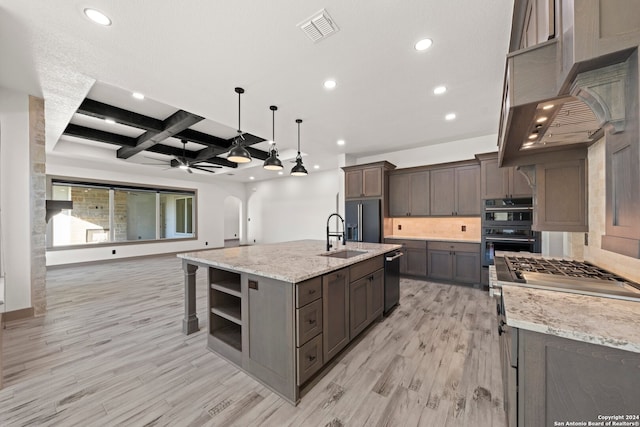 kitchen with coffered ceiling, ceiling fan, light wood-type flooring, appliances with stainless steel finishes, and a large island