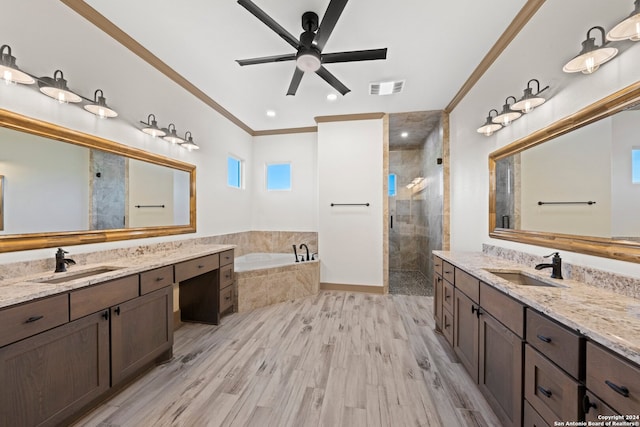 bathroom with hardwood / wood-style floors, vanity, crown molding, ceiling fan, and separate shower and tub