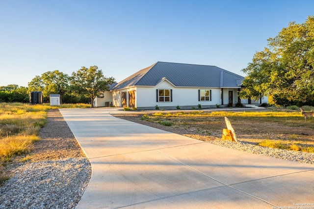 modern farmhouse style home featuring cooling unit