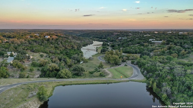 aerial view at dusk with a water view