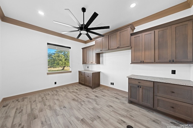 laundry area with cabinets, ceiling fan, light wood-type flooring, and ornamental molding