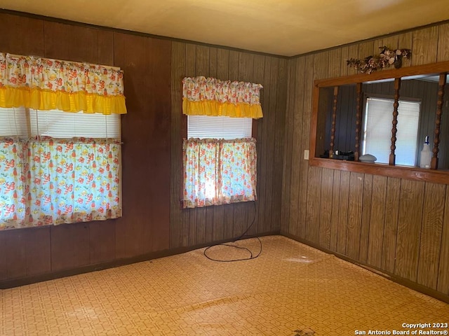 empty room featuring wooden walls