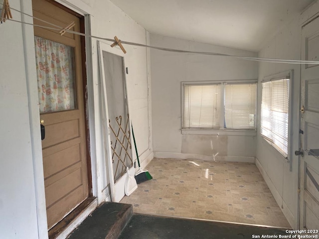 spare room featuring ceiling fan and lofted ceiling