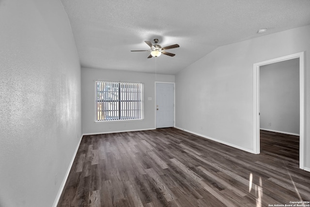 spare room featuring vaulted ceiling, ceiling fan, dark hardwood / wood-style flooring, and a textured ceiling