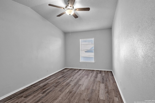 spare room featuring wood-type flooring, a textured ceiling, ceiling fan, and lofted ceiling