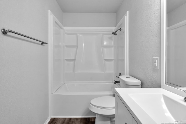 full bathroom with washtub / shower combination, vanity, wood-type flooring, and toilet