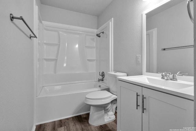 full bathroom featuring hardwood / wood-style floors, vanity, bathtub / shower combination, and toilet