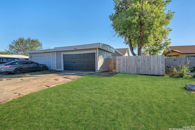 exterior space with a garage and a front lawn