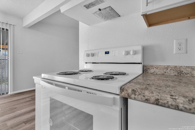 kitchen with white cabinetry, white range with electric cooktop, light hardwood / wood-style floors, a textured ceiling, and exhaust hood