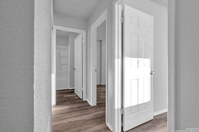 hallway featuring hardwood / wood-style flooring