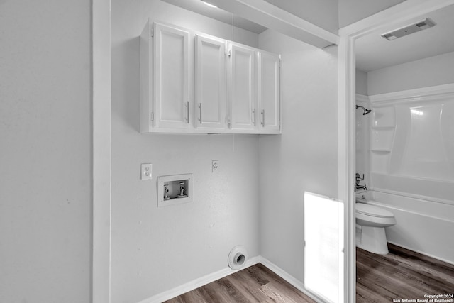 washroom featuring electric dryer hookup, cabinets, hookup for a washing machine, and wood-type flooring