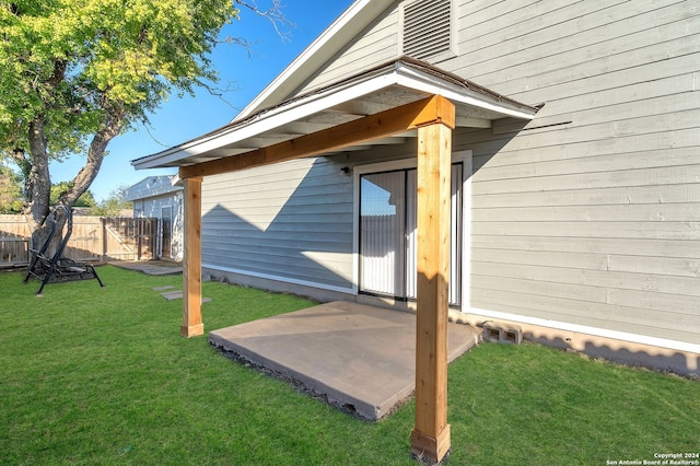 view of exterior entry featuring a yard