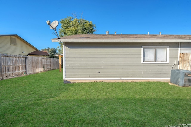 exterior space featuring a lawn and central AC