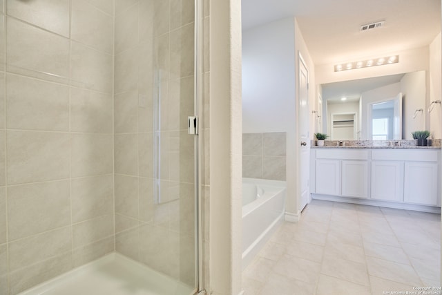 bathroom featuring separate shower and tub, tile patterned flooring, and vanity