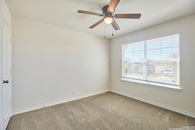 carpeted empty room featuring ceiling fan