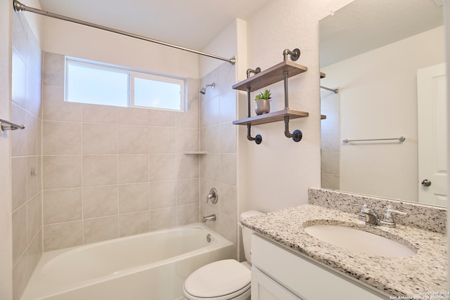 full bathroom with vanity, toilet, and tiled shower / bath combo