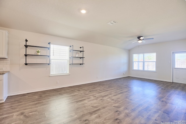 unfurnished living room with hardwood / wood-style flooring, ceiling fan, and vaulted ceiling