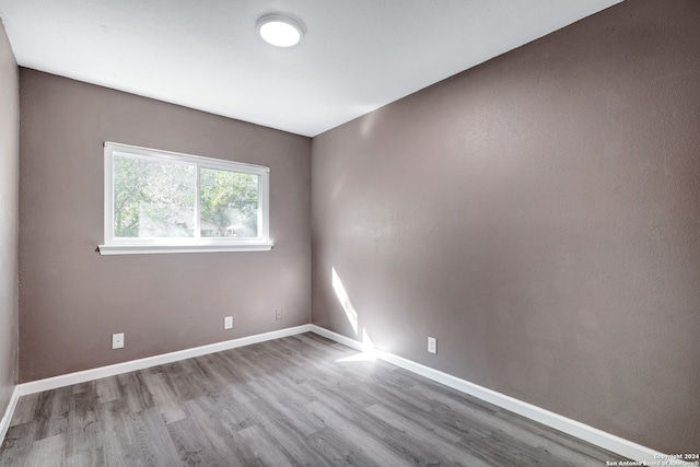 unfurnished room featuring hardwood / wood-style flooring